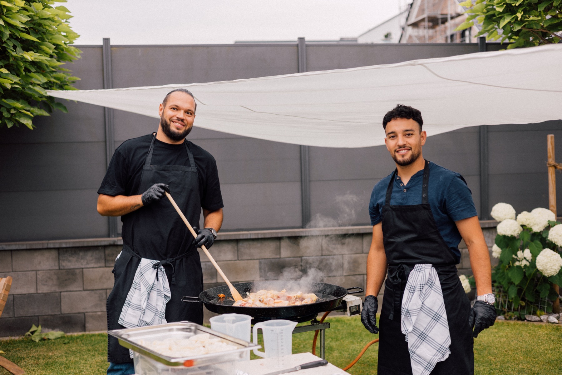 Andy und sein Küchenteam gemeinsam an der Paella-Pfanne bei einer privaten Feier